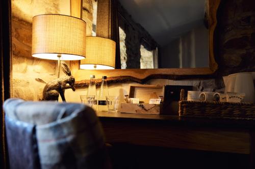 a lamp sitting on a table with a mirror at Barley Mow in Burnley