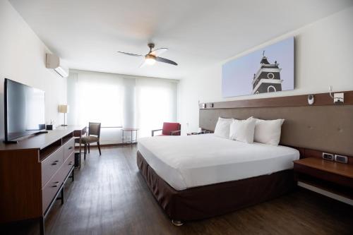 a hotel room with a bed and a tv at Casa Andina Premium Piura in Piura