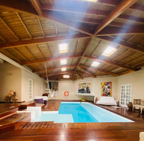 a large indoor swimming pool with a wooden ceiling at Mision Costa in Corralejo