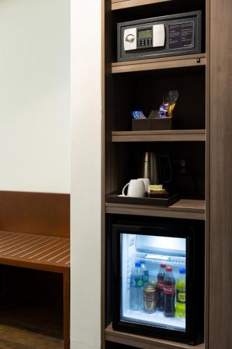 a small refrigerator with drinks inside of it at Casa Andina Premium Piura in Piura