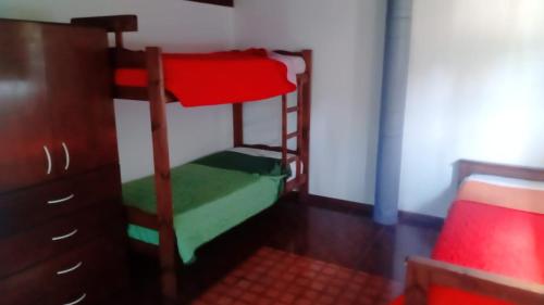 a bedroom with two bunk beds and a dresser at La soñada in Mar Azul
