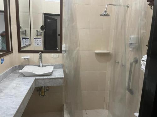 a bathroom with a sink and a shower at Hotel Camino Real Popayán Colombia in Popayan