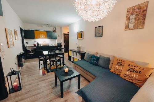 a living room with a couch and a table at Max Holiday Apartment in Pamporovo
