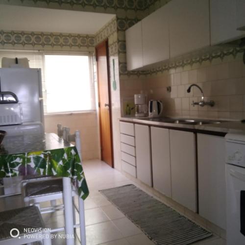 a kitchen with a sink and a counter top at Apartamento Central in Vila Real de Santo António