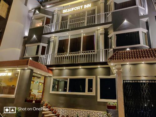 a large building with a balcony on top of it at The Beaufort Inn in New Delhi