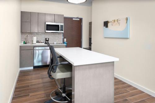 a kitchen with a white counter top in a room at Hyatt House Charlotte Rea Farms in Charlotte