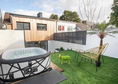 a backyard with a hot tub and a dog in the yard at James' Place at Castle Cottage in Merthyr Tydfil