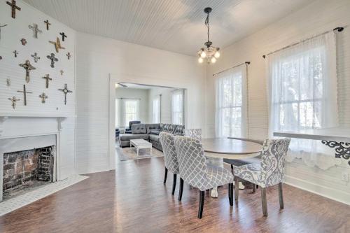 a dining room with a table and chairs and a fireplace at Charming 100-Year-Old Home Less Than 1 Mi to Downtown in Ocala