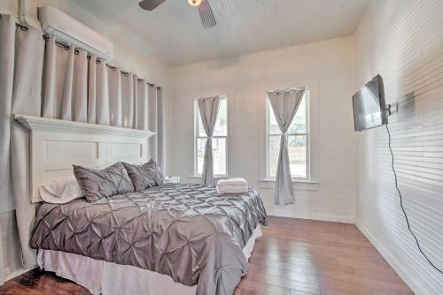 a bedroom with a bed and a flat screen tv at Charming 100-Year-Old Home Less Than 1 Mi to Downtown in Ocala