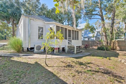 a white tiny house in a yard at Charming 100-Year-Old Home Less Than 1 Mi to Downtown in Ocala