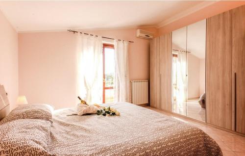 a bedroom with a bed and a large window at VILLA ROGE' in Castellabate