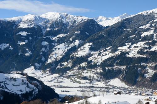a snow covered mountain range with a town in the foreground at Haus Panorama in Gerlosberg