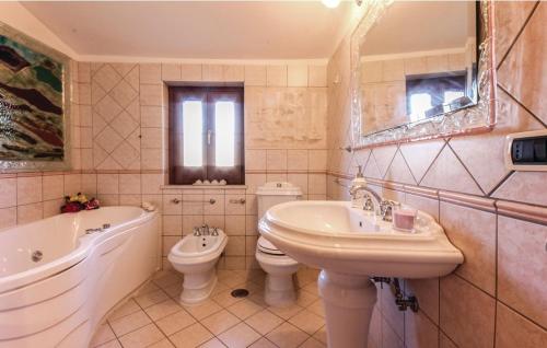 a bathroom with a sink and a tub and a toilet at VILLA ROGE' in Castellabate