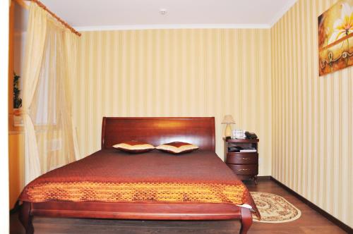 a bedroom with a bed in a room with stripes at Evropeyskiy in Kyiv