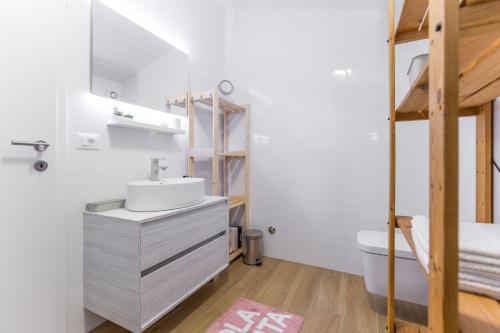 a bathroom with a sink and a toilet at Apartmani Lucija in Poreč