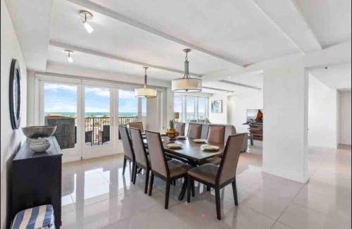 a dining room with a table and chairs at Bahia Mar Solare Tower 6th floor Oceanview Condo 3bd 3ba w Pools in South Padre Island