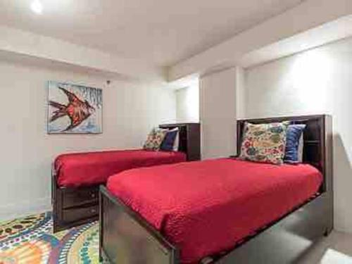 a bedroom with two beds with red covers and a rug at Bahia Mar Solare Tower 6th floor Oceanview Condo 3bd 3ba w Pools Hot Tubs in South Padre Island