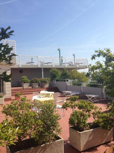 a patio with tables and chairs on a building at Hotel President in Chianciano Terme