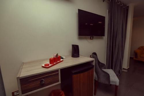 a room with a desk with red shoes on it at Brothers Pyramids View in Cairo