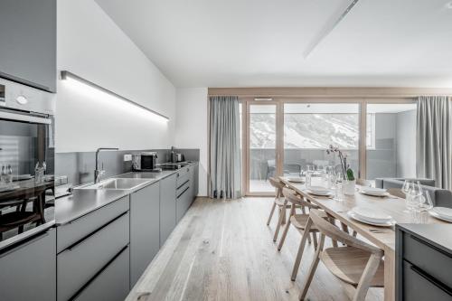 a kitchen with a table and a dining room at all inclusive Hotel Lohmann in Obergurgl