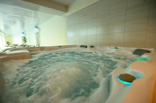 a large jacuzzi tub in a bathroom at Parklands Hotel & Pool in Bansko