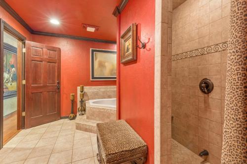a bathroom with red walls and a tub and a shower at The Funky Monkey Inn in Afton