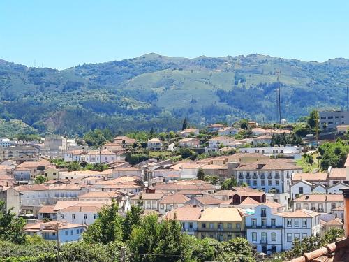 a town with houses and mountains in the background at Lodges Minho in Ponte da Barca