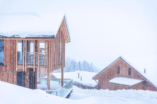a couple of barns in the snow at Bergresort Hauser Kaibling by ALPS RESORTS in Haus im Ennstal