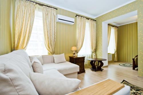 a living room with a white couch and a table at Evropeyskiy in Kyiv
