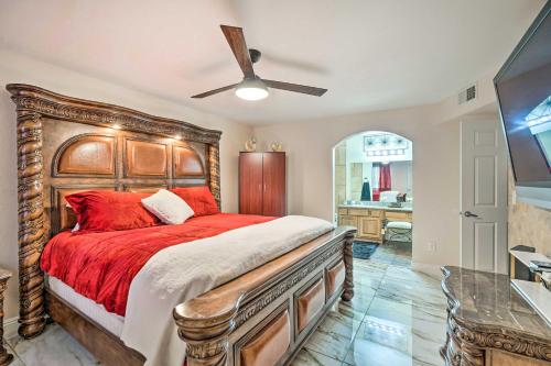 a bedroom with a large wooden bed with red pillows at Seasonal Pool and Spa Las Vegas Pad, 11 Mi to Strip in Las Vegas