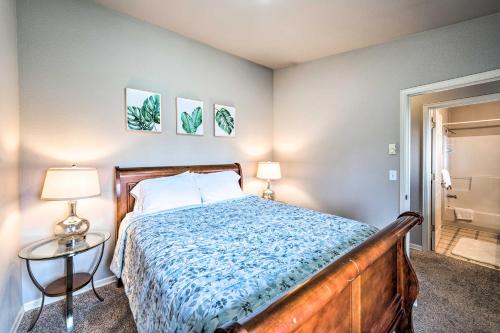 a bedroom with a bed and a table and two lamps at Apartment with Patio and Grill Access about half Mi to Bay! in Anacortes