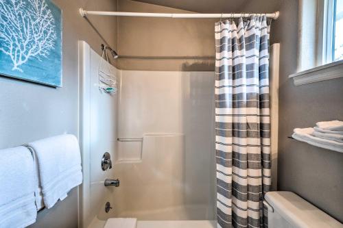 a bathroom with a shower with a shower curtain at Apartment with Patio and Grill Access about half Mi to Bay! in Anacortes