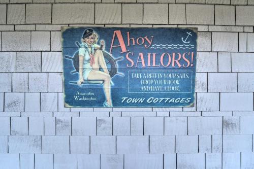 a sign on the side of a brick wall at Apartment with Patio and Grill Access about half Mi to Bay! in Anacortes