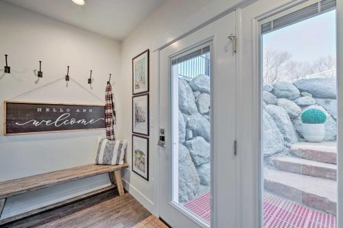 a hallway with a door and a bench and stairs at Vibrant Chic Home about 20 Mi to Salt Lake City! in Draper
