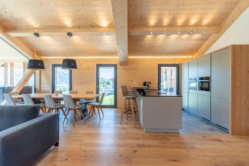 a kitchen and dining room with a table and chairs at Bergresort Hauser Kaibling by ALPS RESORTS in Haus im Ennstal