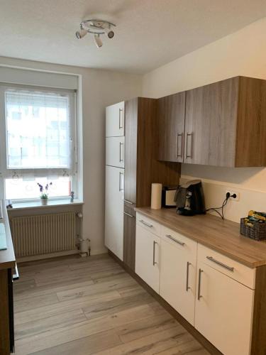 a kitchen with a white refrigerator and a window at Grenznahe Ferienwohnung mit 4 Schlafzimmern in Grenzach-Wyhlen
