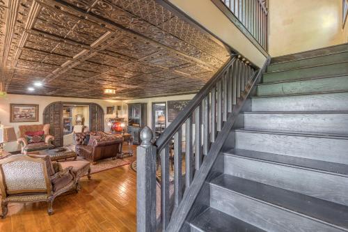a staircase in a home with a wooden ceiling at The Funky Monkey Inn in Afton
