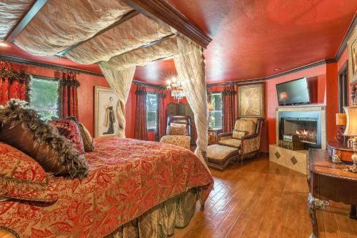 a bedroom with a large bed and a fireplace at The Funky Monkey Inn in Afton