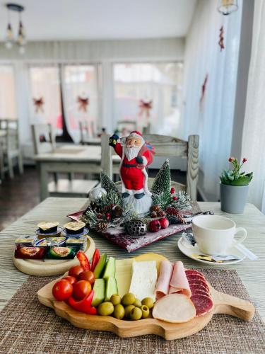 a table with a tray of fruit and vegetables on it at CASA ANKELI in Buşteni