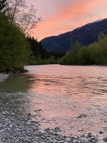 a view of a river at sunset at Ferienwohnung Wildkogelblick in Bramberg am Wildkogel