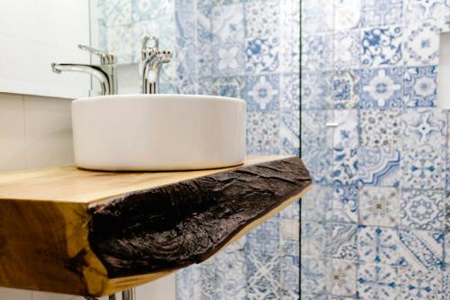 a sink on a wooden counter in a bathroom at The Cranky Croc Hostel in Bogotá