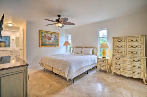 a bedroom with a bed and a ceiling fan at Direct Gulf Access and Lanai Sunny Naples Home! in Naples