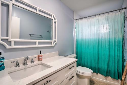 a bathroom with a sink and a green shower curtain at Direct Gulf Access and Lanai Sunny Naples Home! in Naples