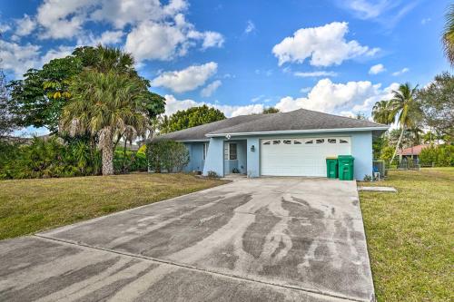 a house with a garage with graffiti on the driveway at Direct Gulf Access and Lanai Sunny Naples Home! in Naples