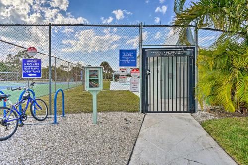 a gate with a bike parked next to a fence at Direct Gulf Access and Lanai Sunny Naples Home! in Naples