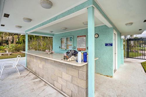 a outdoor kitchen with a blue wall at Direct Gulf Access and Lanai Sunny Naples Home! in Naples