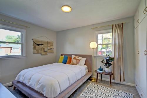 a bedroom with a large bed and two windows at Wilson Circle in Boise