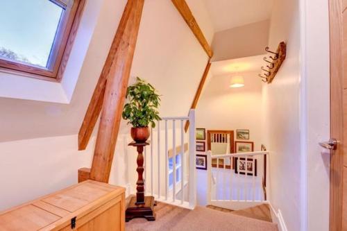 a room with a staircase with a potted plant at Sleepy Hollow in Whitby