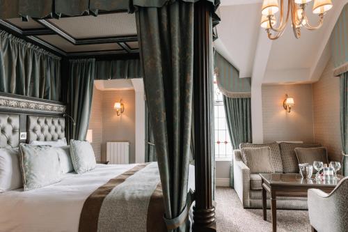 a hotel room with a bed and a couch at The Old Inn in Crawfordsburn