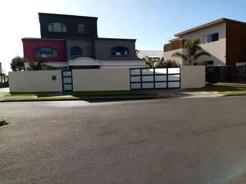 a house with a fence and a driveway at Three bedrooms two bathrooms ground floor only not the whole house in Mount Maunganui